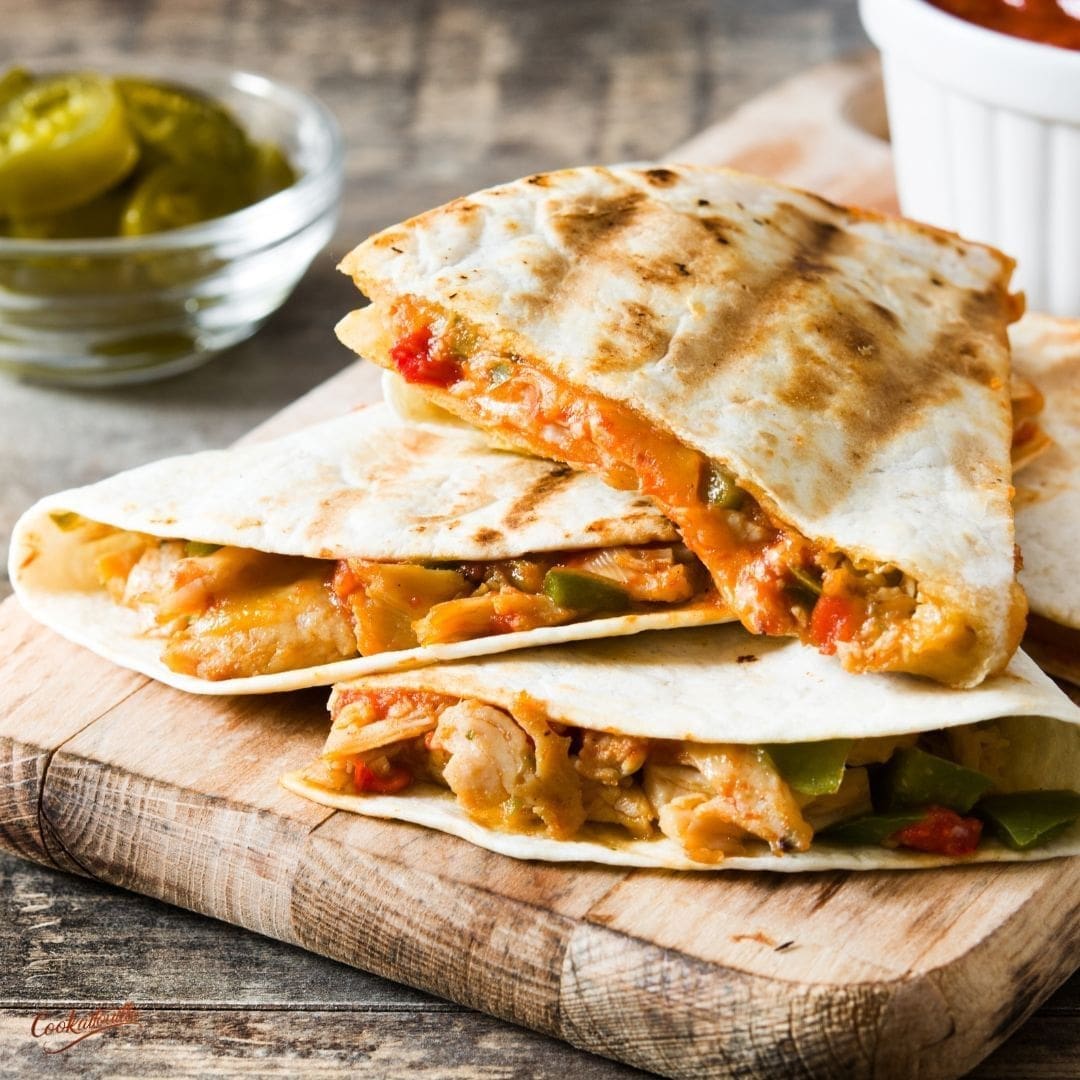 This Grilled Chicken Quesadilla features juicy, marinated chicken, smoky grilled bell peppers, caramelized onions, and gooey melted cheese, all sandwiched between crispy golden tortillas.